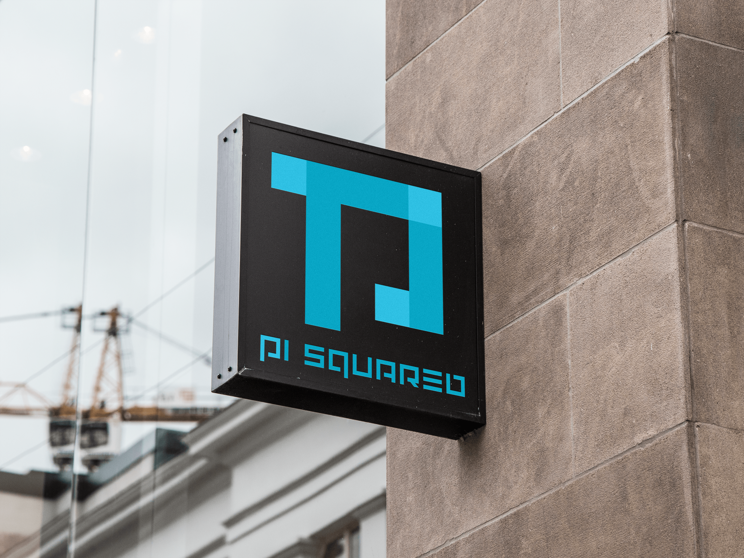 Pi Squared sign mounted on a building façade
